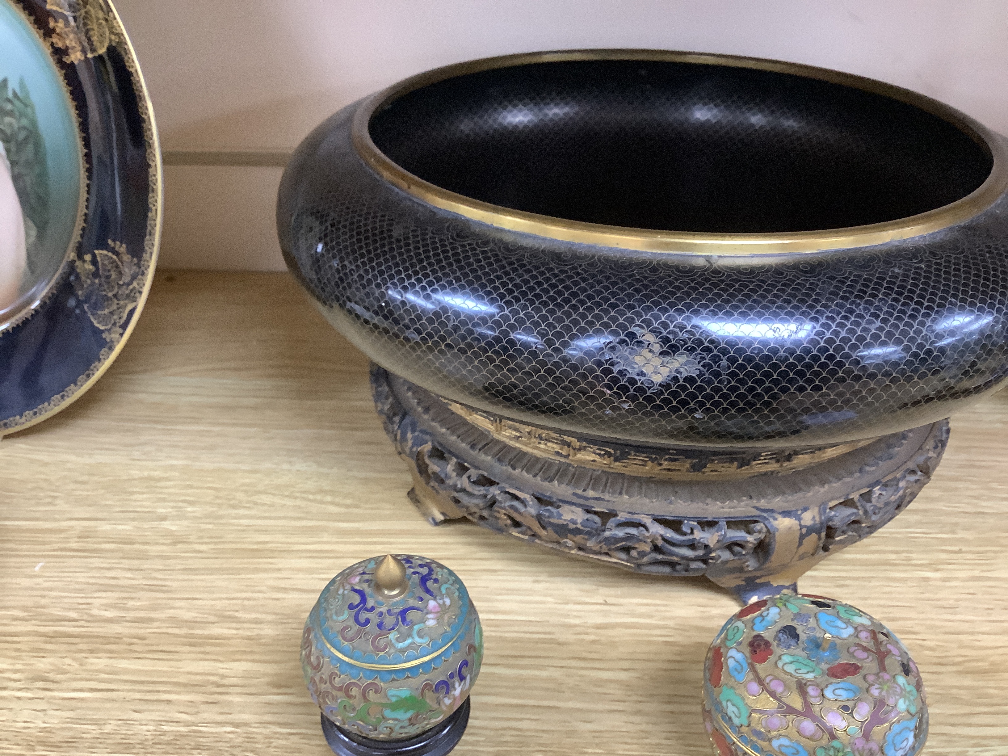 A Chinese cloisonné enamel bowl on partially giltwood stand together with two miniature enamelled pots, one in the form of an apple, largest 30cm diameter